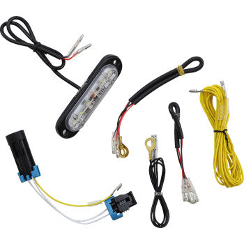The Polaris Reverse Light Kit by Powermadd includes a small LED strip, assorted colored wires with connectors, and electrical terminals with an IP67-rated design—arranged on a white background.