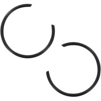 Two black, circular Circlip by Wiseco components with open ends are arranged diagonally on a white background—perfect for secure piston installation in high-silicon alloy pistons.