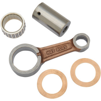 The Yamaha Connecting Rod Kit by Hot Rods includes a metal rod labeled HOT RODS, a cylindrical pin, a needle roller bearing, and two washers, all made from premium 8620 AISI steel for superior reliability and durability.