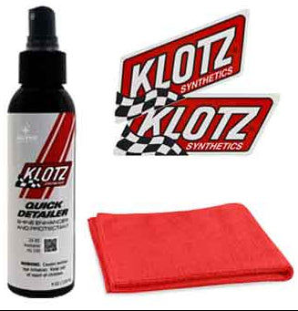 The Quick Detailer Kit by Klotz includes a bottle of motorcycle detailer spray, two red and white checkered flag Klotz Synthetics stickers, and a folded red microfiber cloth for a lasting showroom shine.