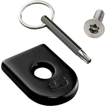 The Security Seat Screw - Black by Saddlemen includes a black star-shaped security screw, a matching key ring, and a rectangular lock plate with a circular hole—ideal for securing your Saddlemen seat.