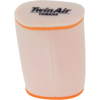 The Yamaha Standard Air Filter by Twin Air is a cylindrical, dual-stage foam filter with rounded edges and orange trim, designed to optimize airflow for peak performance. "Twin Air Yamaha" is labeled on the top.
