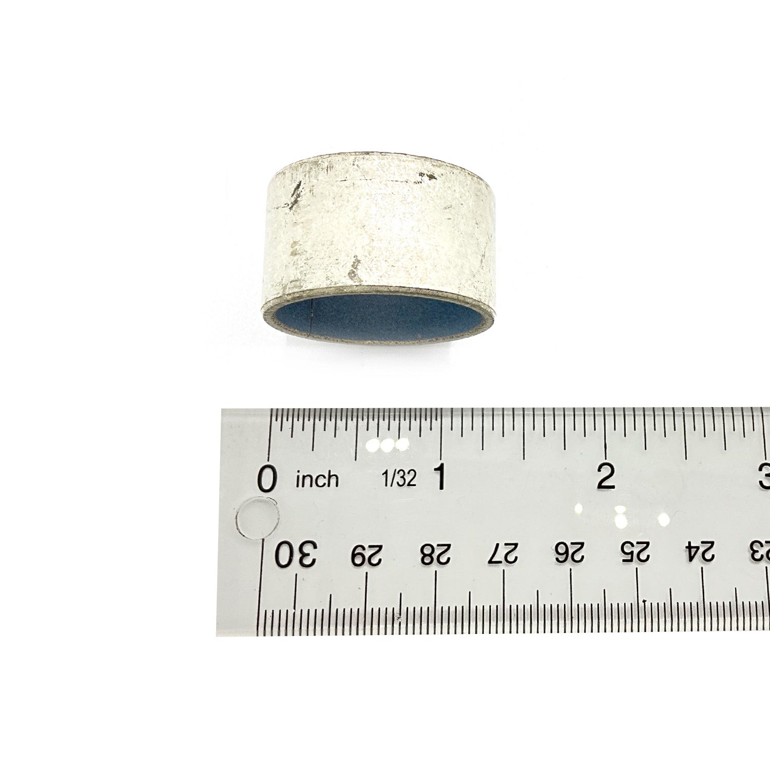 Small cylindrical metal bearing cover with a silver finish, shown next to a ruler for size reference.