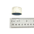 Small cylindrical metal bearing cover with a silver finish, shown next to a ruler for size reference.