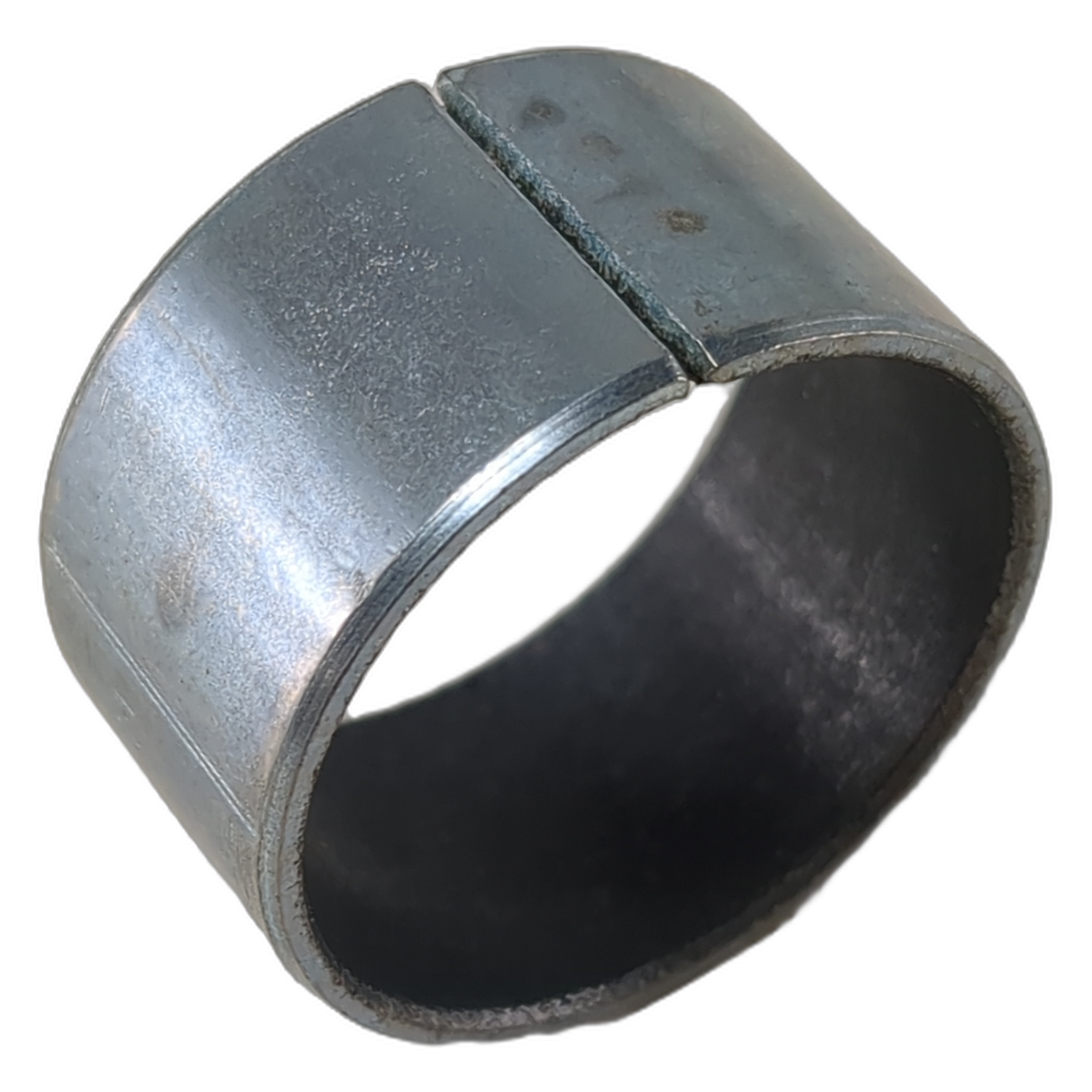 Metal cylindrical bearing sleeve with a slit and smooth inner surface, silver-gray finish.