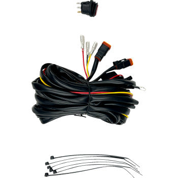 The Wire Harness Dual 55 by Heretic features connectors, an inline fuse, a black and red switch, and several black cable ties, all arranged on a white background.