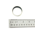 Metal moveable 1/2 inch bushing with dark inner lining shown next to a metal ruler for size reference.