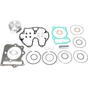 Silver metal piston with a circular, machined top alongside black, blue, and copper-colored gaskets and seals arranged on a.