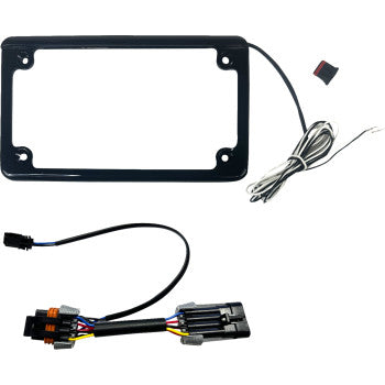 The Polaris RZR Turn Signal Kit Front & Rear Black by Custom Dynamics is shown on a white background with a black license plate frame, wiring, a red and black electronic component, and a plug-and-play harness with multicolored wires and connectors.