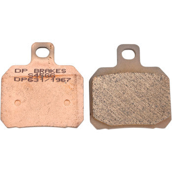 Two Standard Brake Pads by Dp Brakes are shown side by side. The left pad features DP631 engraved, while the right shows a textured sintered metal friction surface. Both pads include a top tab with a hole.
