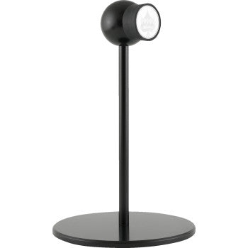A modern black desk lamp with a round base, slim stem, and forward-facing spherical shade. Its minimalistic design pairs perfectly with the Stand iOmounts™ Black by Klock Werks for a sleek, contemporary workspace.