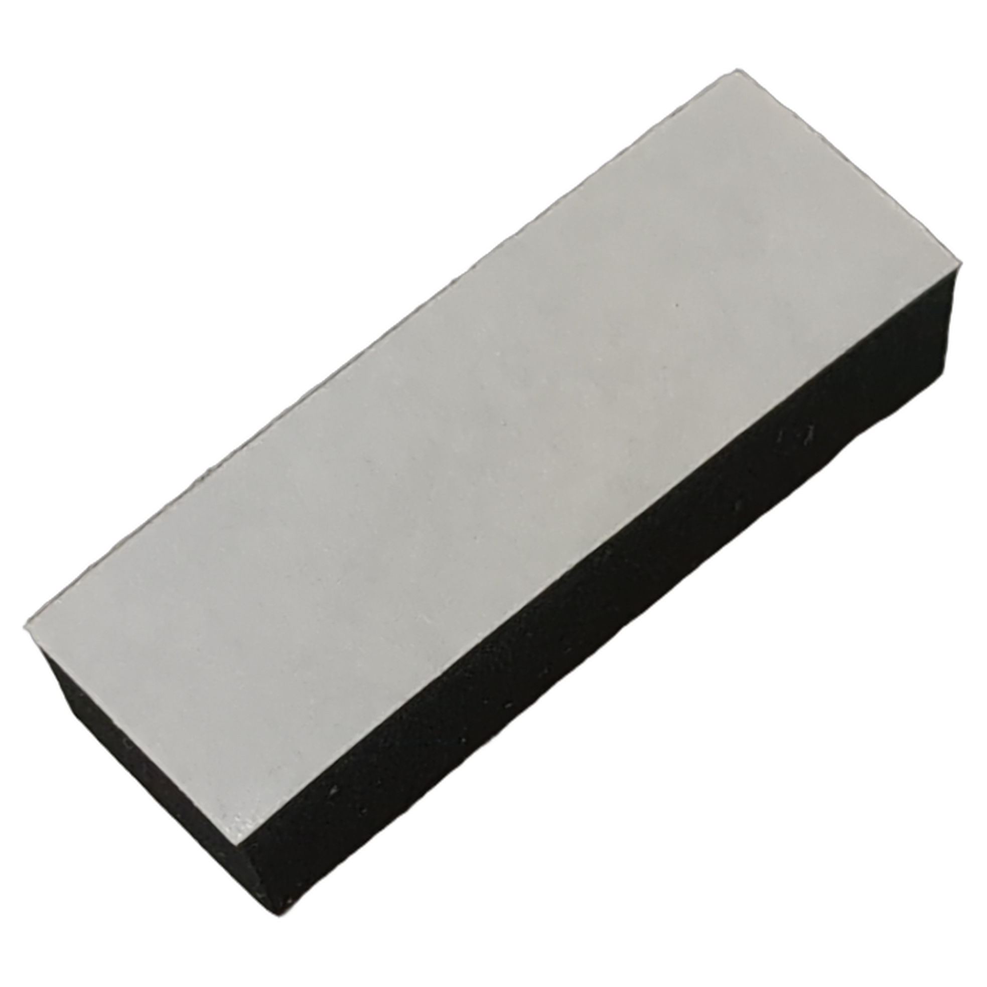 Rectangular black and gray rubber pad with smooth surface, slightly tapered edges.