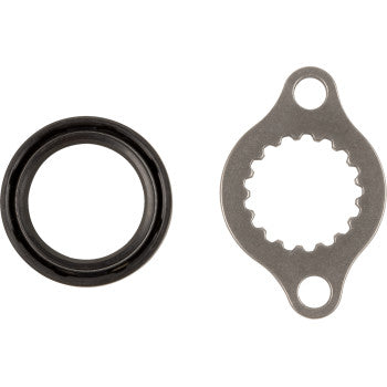 On the left, the Honda Transmission Seal Output Shaft by Hot Rods in black; on the right, a metallic sprocket nut washer with two holes—both displayed against a white background.