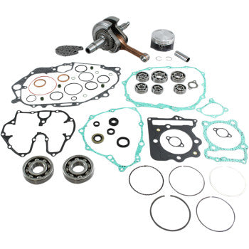 Complete Honda TRX engine rebuild kit with gaskets, seals, piston, crankshaft, and bearings arranged on a white background.