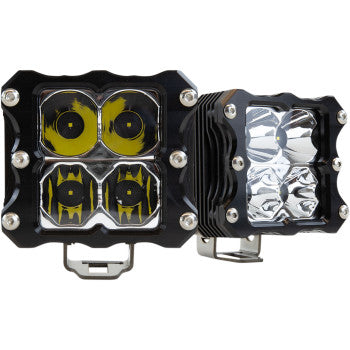 The LED Quattro Light Spot Flood Pair by Heretic includes two square off-road lights with black housings—one with yellow-tinted lenses, one clear—each featuring four visible CREE LEDs and robust metal bottom mounting brackets.
