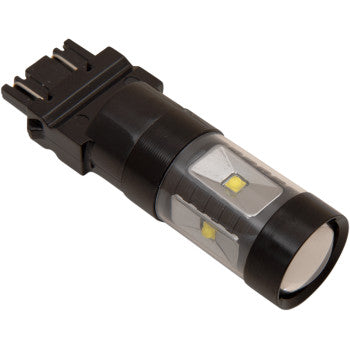 A close-up of the 3157 LED Taillight Bulb by Headwinds shows a black, cylindrical design with a clear casing and visible yellow LEDs. Its low voltage draw and black plastic base allow for efficient automotive installation.