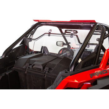 A close-up view of a red off-road vehicle’s interior showcases the rear cargo area, black storage box, and the Poly Rear Windshield UV Resistant by Seizmik attached to the roll cage.