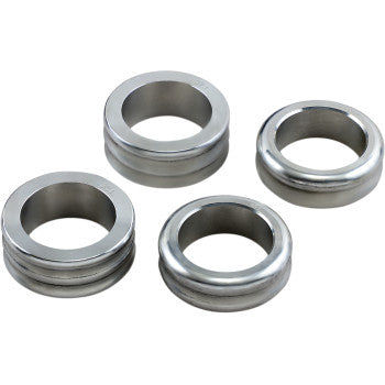 Four metallic, circular grommets with smooth, shiny surfaces are arranged on a white background. Perfect for use with the Lift Kit Front Back 1.50 2.00 by High Lifter, each features a central hole and raised edges for added clearance in ATV installations.