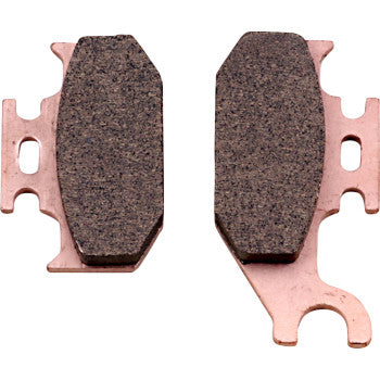 Two brown, rectangular ceramic Brake Pads by Galfer with copper-colored metal backing plates are side by side on a white background. One aggressive pad has an extended tab ending in a curved hook-like shape.