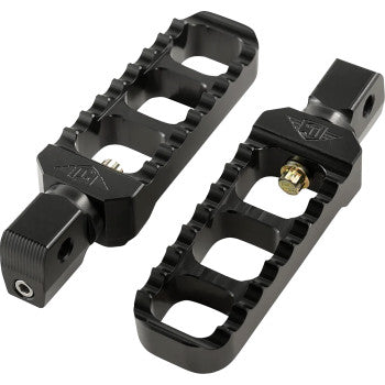 The Serrated Footpegs - Black - Narrow by Joker Machine are CNC-machined aluminum footpegs with ridged grips, open slots, adjustable fit, and a visible mounting post and bolt for secure motorcycle installation.