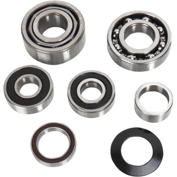 Seven assorted bearings and washers from the Transmission Bearing Kit by Hot Rods are shown on a white background, featuring both open and sealed designs—perfect for engine cases, shift drum, or transmission installation.