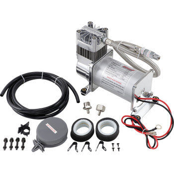 The Kleinn Air Compressor 150 PSI / 50% is a portable medium duty 12-volt kit with hoses, power cables, mounting hardware, two tape rolls, clips, and a round plastic case—all arranged on a white background.