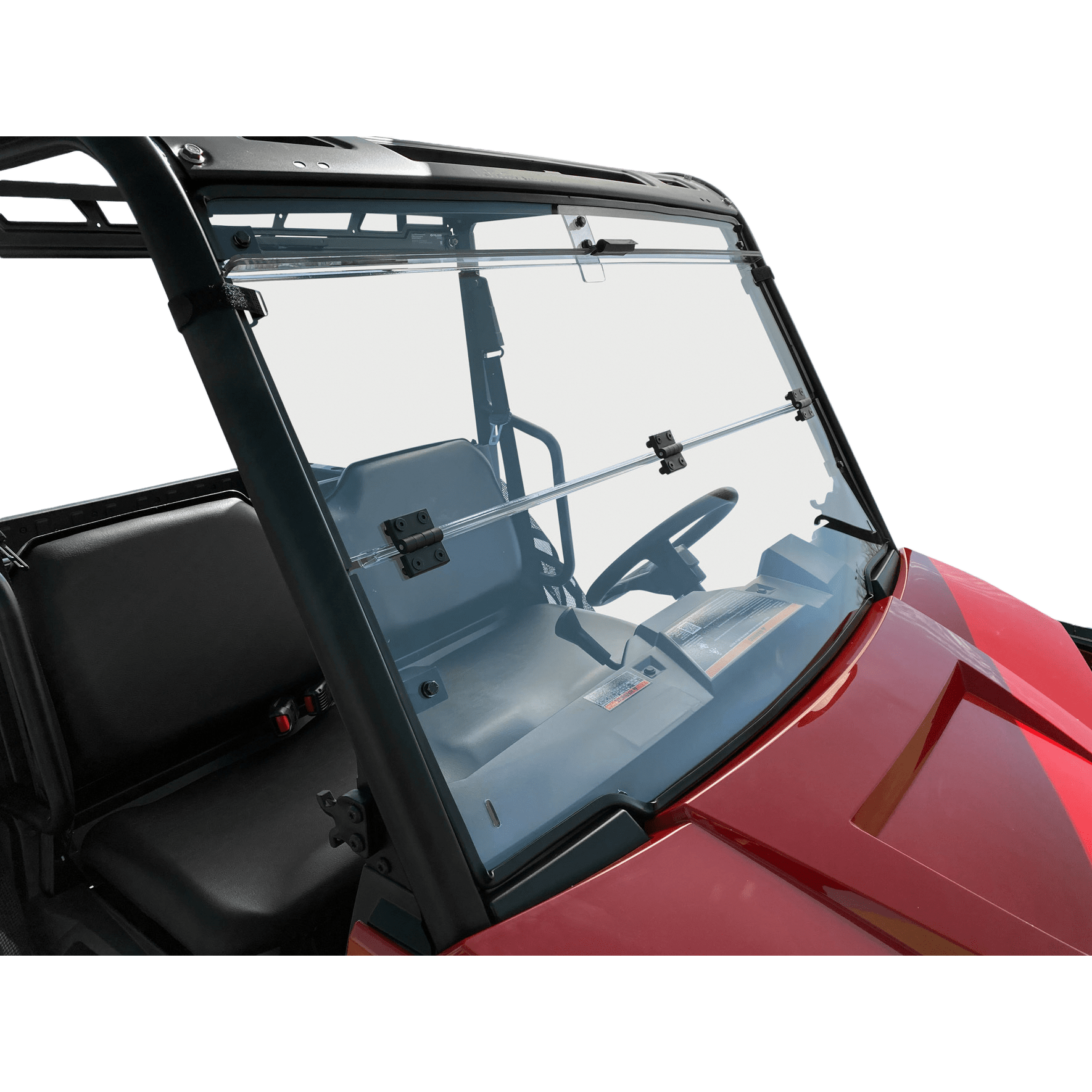 Close-up of the Folding Windshield by Open Trail installed on a red UTV, showing its clear foldable design along with part of the dashboard, steering wheel, and two black seats.