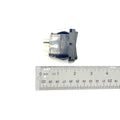 Black rectangular all wheel drive switch with silver metal connectors and textured grip button next to clear ruler showing.