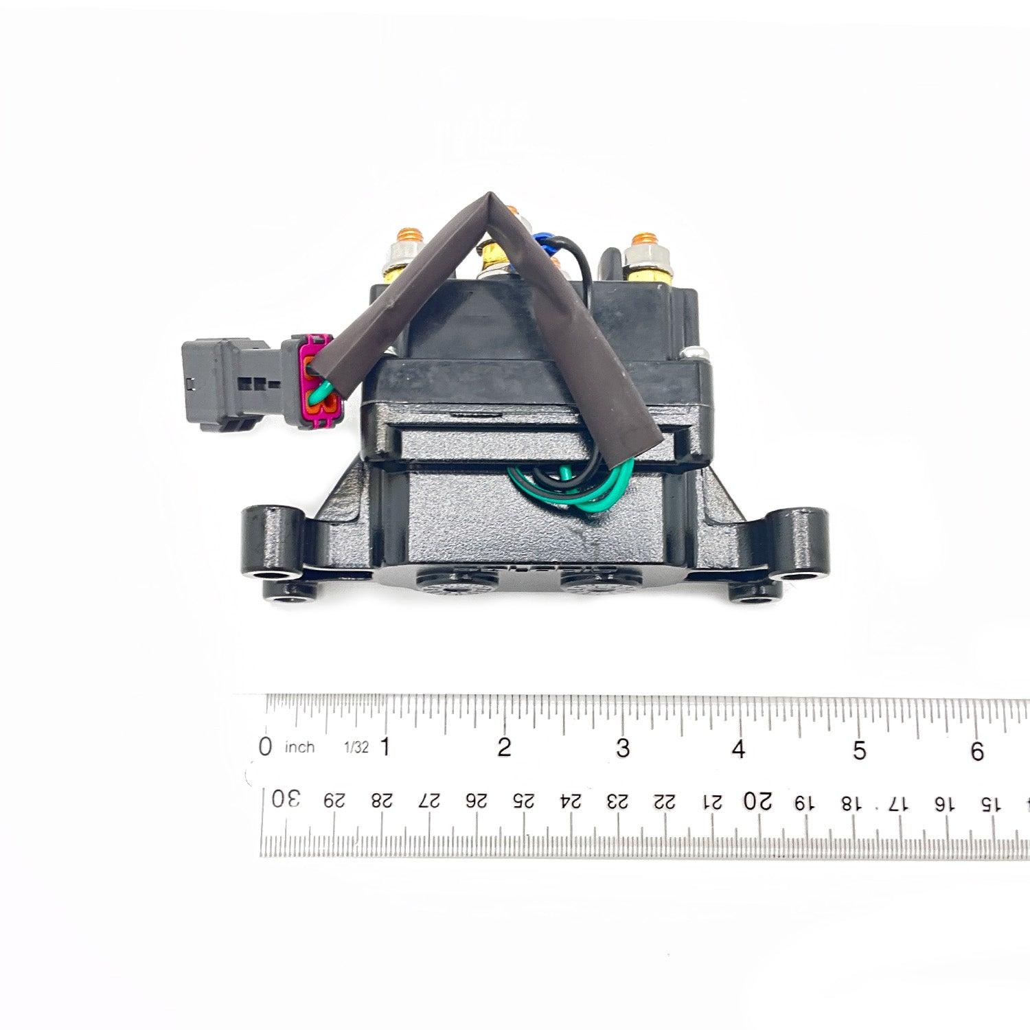 Black plastic and metal Polaris winch contactor with attached wiring and connectors, shown with ruler for scale.