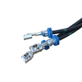 Close-up of two black electrical wires with blue rubber grommets and metal crimp terminals for Stator by Polaris—perfect for those needing genuine Polaris parts or Indian motorcycle OEM components. Shown on a white background.