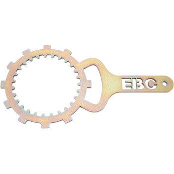 The Yamaha Clutch Basket Holding Tool by EBC is a metal tool with a circular, gear-like end and a flat handle featuring "EBC," designed to hold clutch baskets in place when securing or removing clutch retainer bolts.