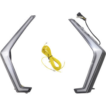 The Polaris RZR Turn Signal by Moose Offroad is shown as two angular, L-shaped LED lights facing each other, with a yellow wiring kit and connector between them. Made of durable ABS with a good seal for lasting performance.