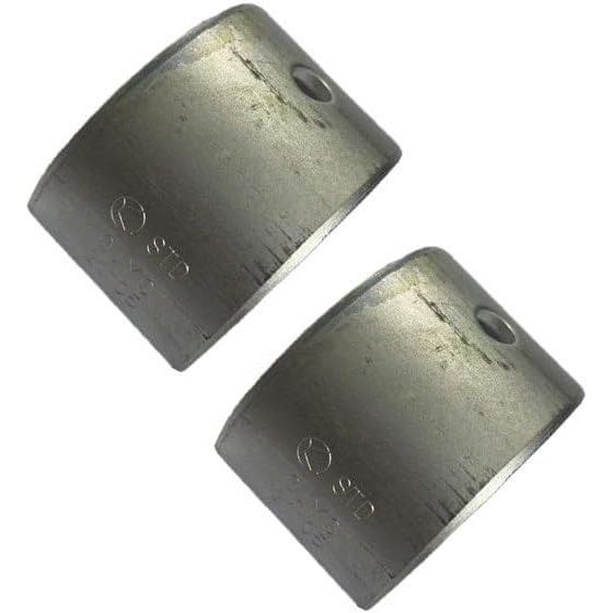 Pair of curved silver metal plain bearing halves with small holes and engraved markings.