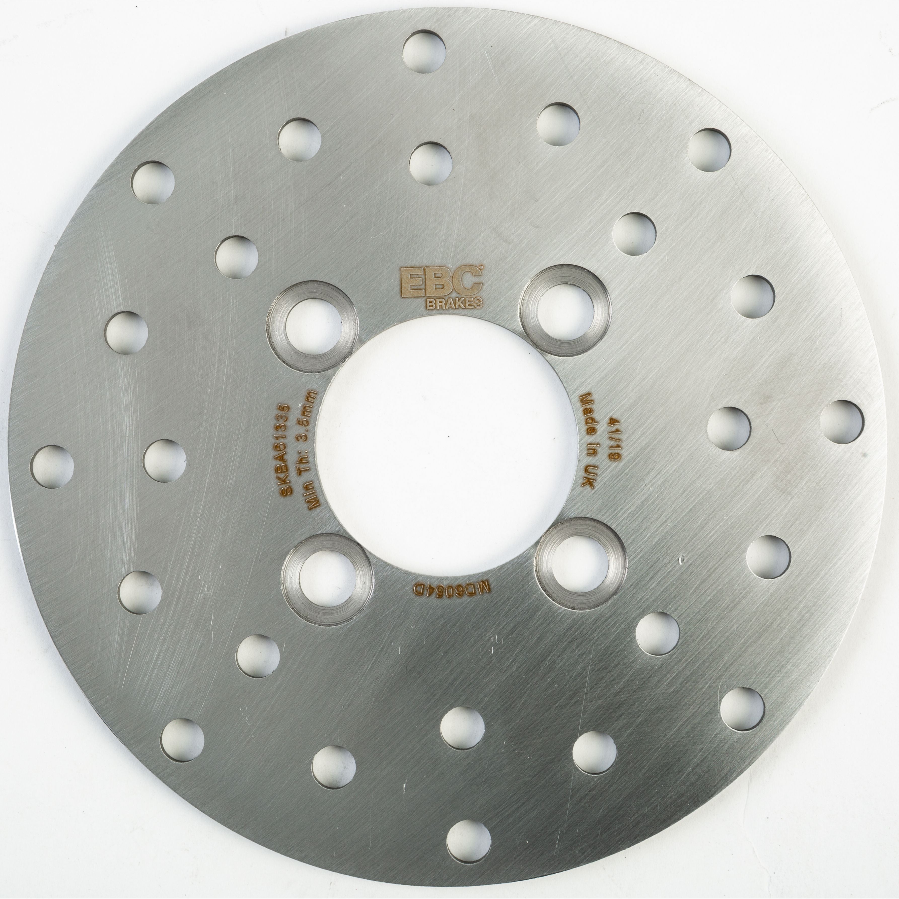 Silver circular metal brake rotor with evenly spaced round ventilation holes and central mounting holes, EBC logo and text.