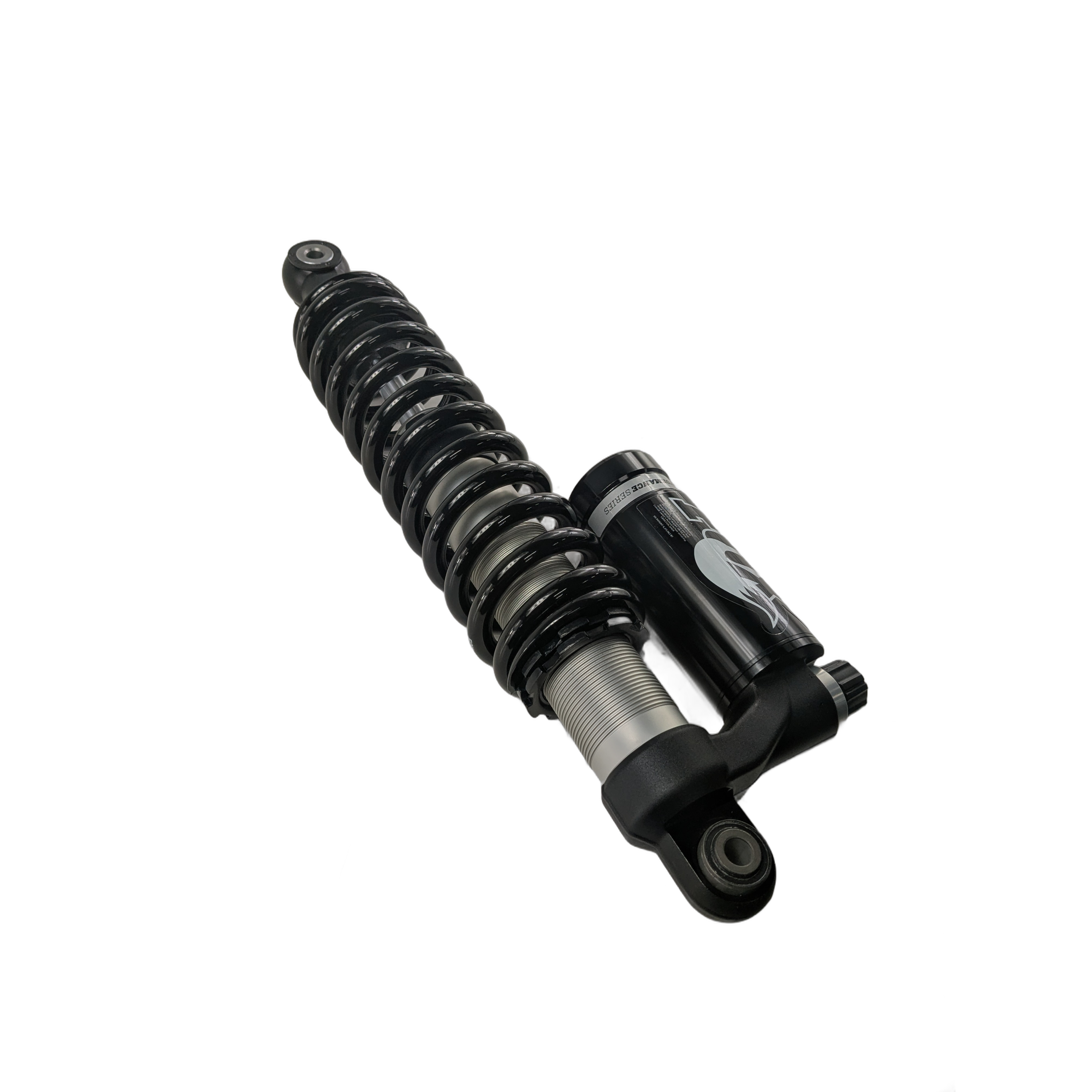 Black front shock absorber with coil spring and attached reservoir, designed for off-road use.