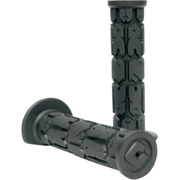 The ATV Rogue Single Ply Grips Black by Odi, featuring mud-resistant, textured geometric patterns, are shown with one grip flat and the other upright. These 7/8" handlebar grips deliver style and improved control for motorcycles or bicycles.