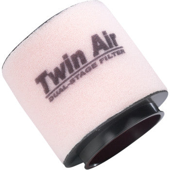 The Honda Standard Air Filter by Twin Air is a cylindrical dirt bike filter with "Dual-Stage Filter" printed on it, featuring light pink foam and a black base for superior engine protection.