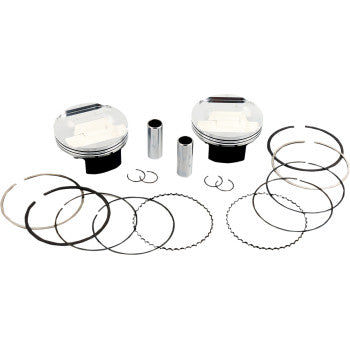 Two silver aluminum pistons with black bases, accompanied by piston pins, circlips, and multiple circular piston rings.