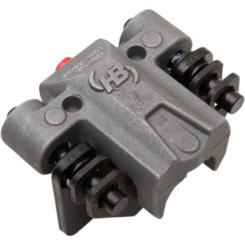 A close-up of the Arctic Cat Brake Caliper Left by Quad Logic shows visible mounting bolts, dual cylindrical pistons per side, a textured finish, OEM alternative brake pads, and the HB logo embossed on top.