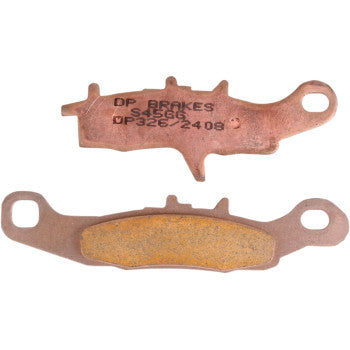 The Kawasaki - Suzuki Standard Brake Pads by Dp Brakes are sintered metal pads shown with one side displaying text and the other the friction surface. Each pad features end holes for mounting and provides fade-free braking performance.