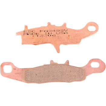 Two SV Severe Duty Brake Pads by Ebc are shown side by side—one revealing the friction surface, the other its engraved backing plate. Both provide ultra-long pad life, perfect for demanding utility mud and sand applications.