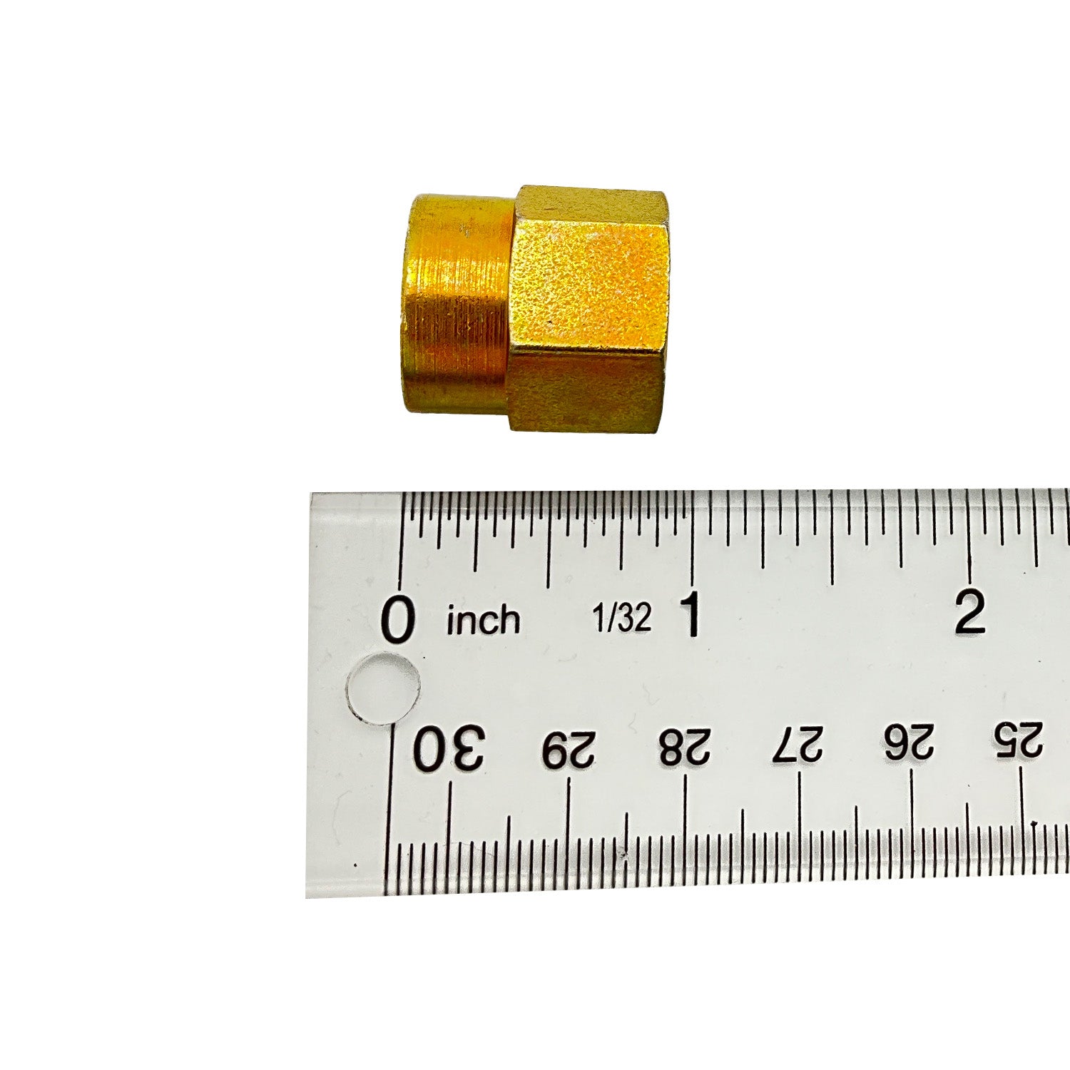 Small gold-colored metal spacer with hexagonal body, shown next to a ruler for scale.