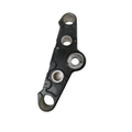 Matte black metal triple tree clamp with circular mounting holes and smooth contoured edges.