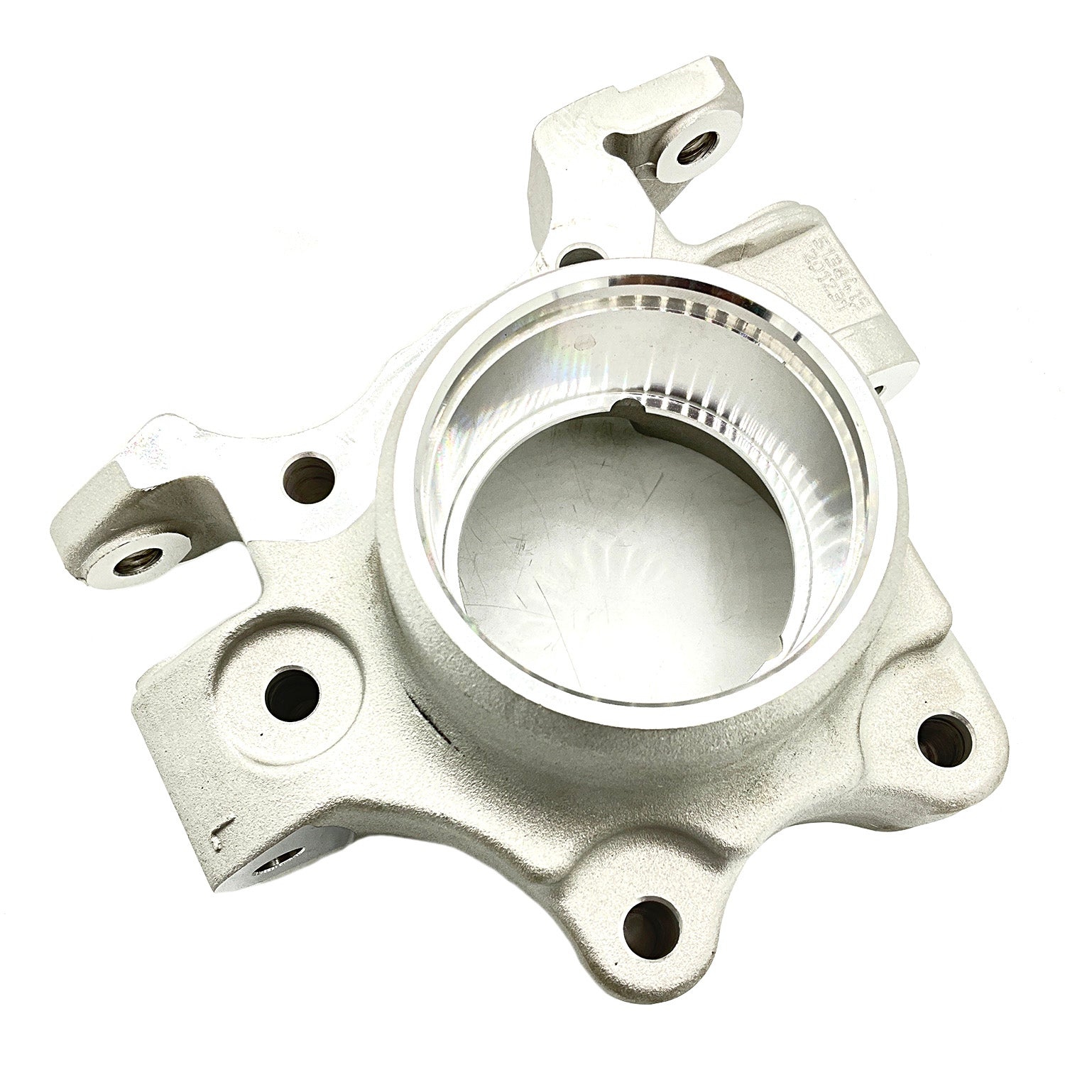 Silver metal left steering knuckle with circular central hub and multiple mounting points.