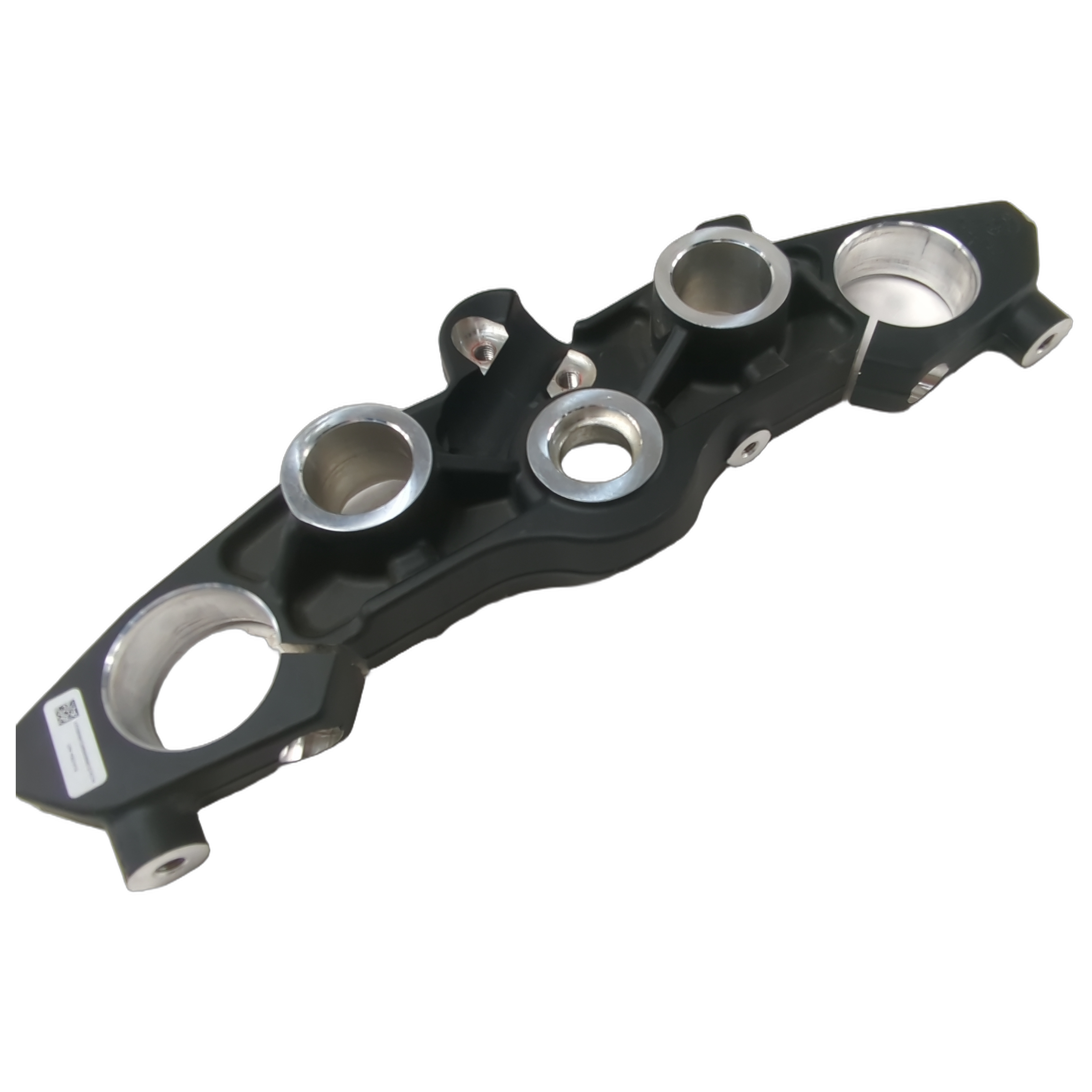 Black upper triple tree clamp with circular mounts and silver metal inserts for motorcycle steering assembly.