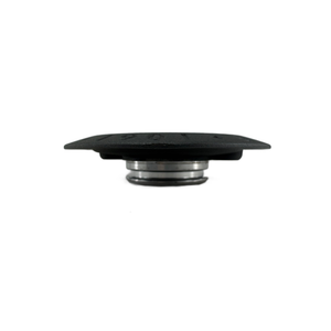 A low-profile, round titanium Cold Start Badge by Polaris with a flat top and metallic base, photographed against a white background; resembles a mechanical accessory, designed for Indian motorcycles.
