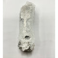 Clear plastic bubble wrap covering a long, irregular-shaped mechanical part with visible dark metal ends.