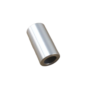 A smooth, metallic, cylindrical Handlebar Isolator Bushing by Polaris with a hollow center is positioned at an angle on a plain white background.