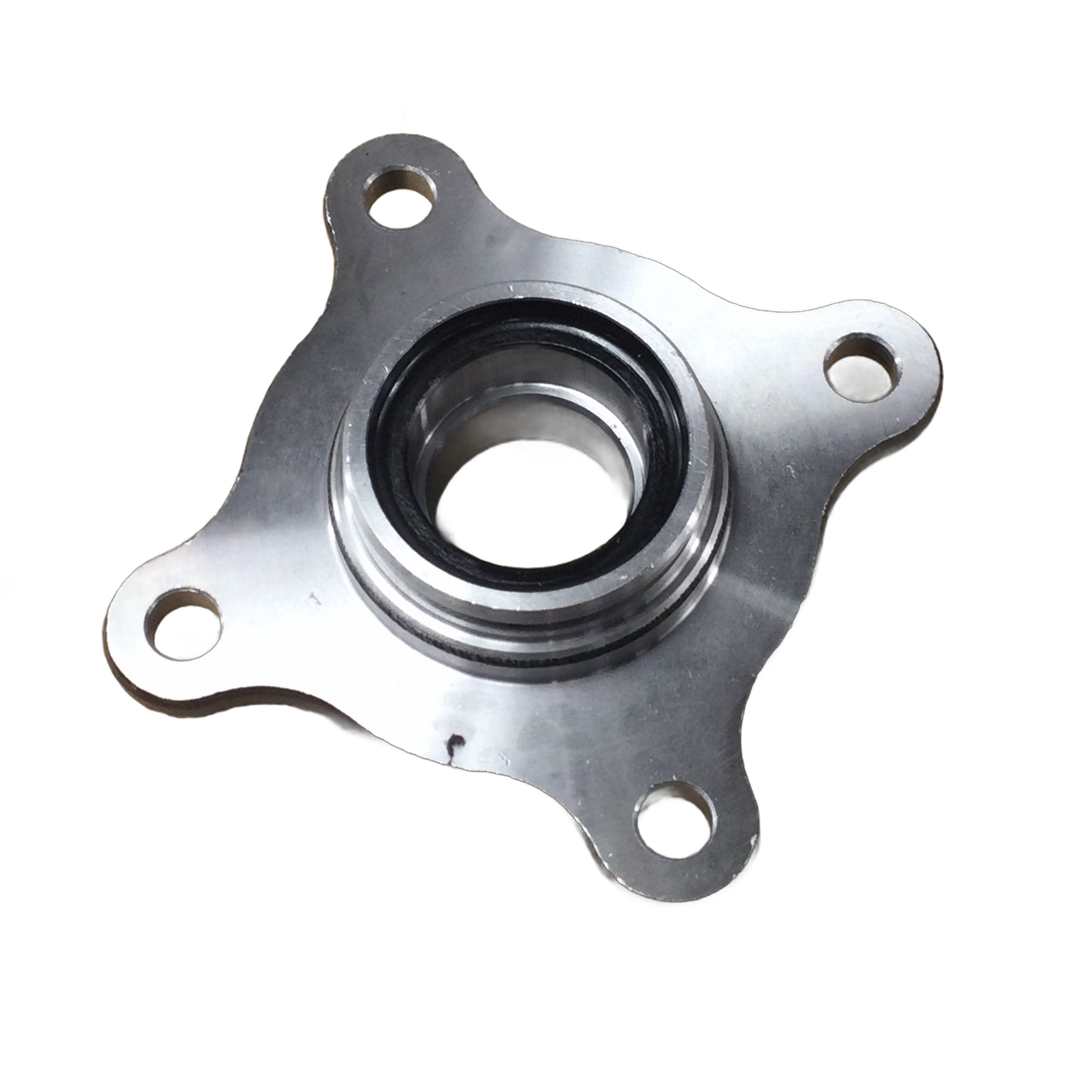 Silver metal front hub with central bearing and four mounting holes in triangular layout.