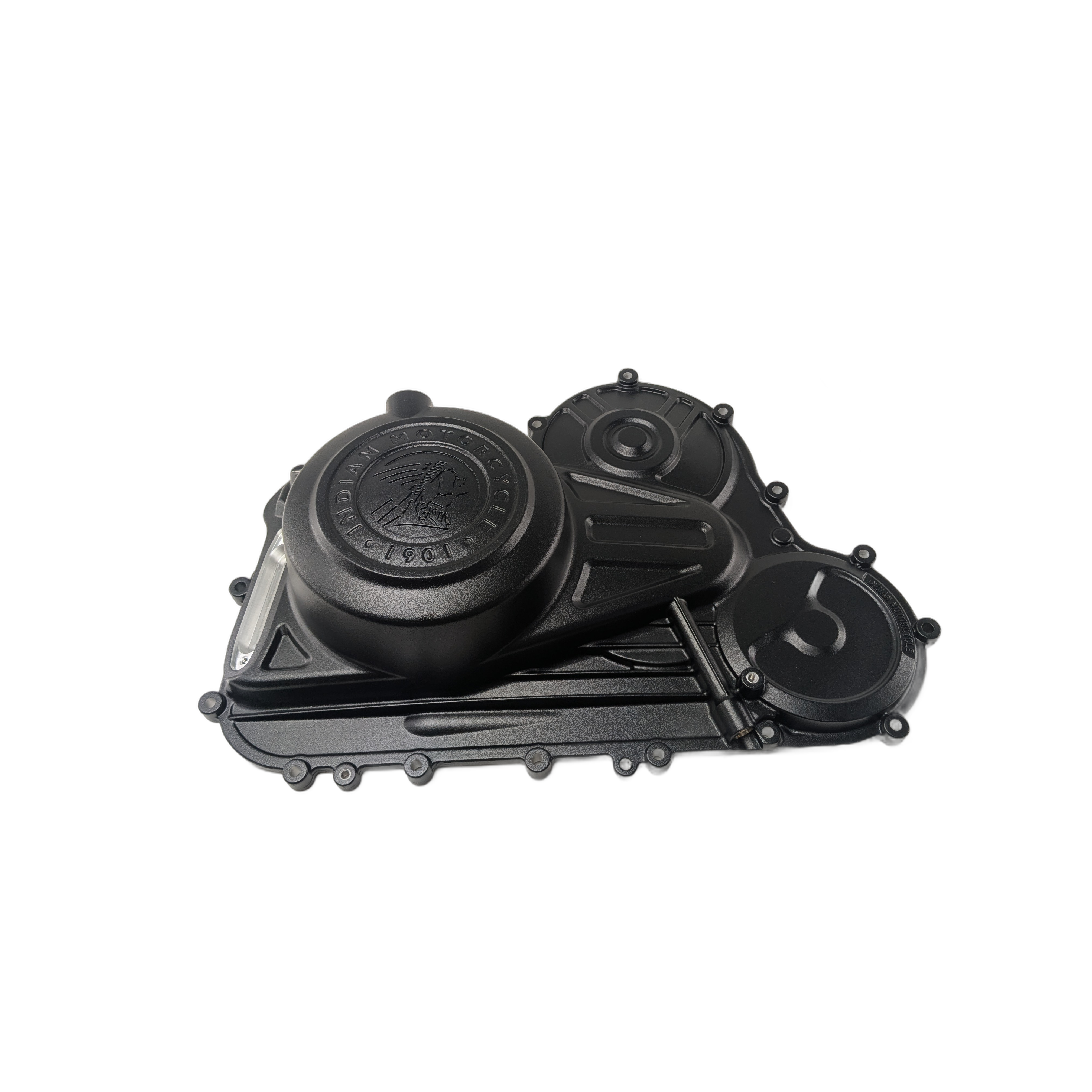 Matte black machined metal primary drive cover with circular embossed design and multiple mounting points.